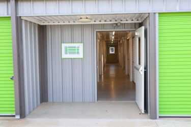 Entrance to indoor climate-controlled storage units between two outdoor drive-up storage units