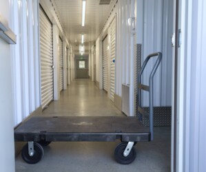 A moving dolly in a hallway of climate-controlled storage units