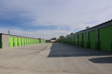 row of drive-up storage units with wide driveway aisle