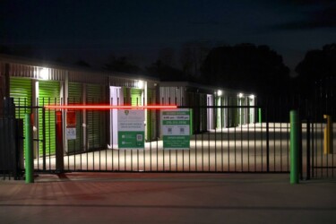 The entrance gate to the facility at night